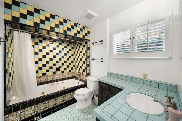 a bathroom with a sink toilet and a mirror