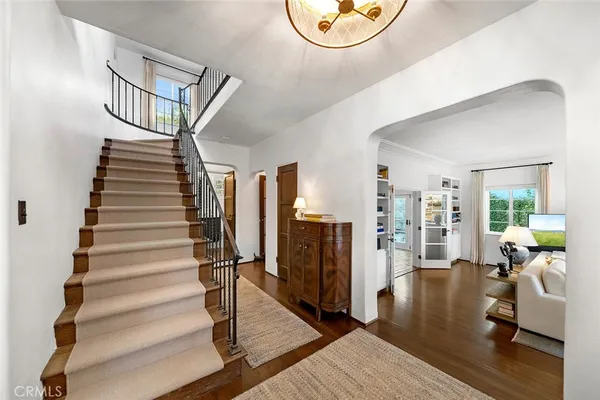 a dining room with furniture and wooden floor