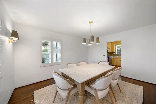 a view of a dining room with furniture and window