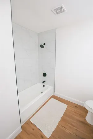 a bathroom with a tub and shower