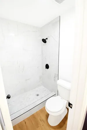 a bathroom with a toilet and a shower