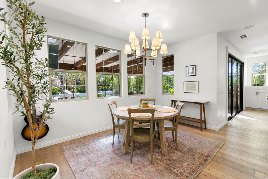 7001 Sitio Frontera Carlsbad, CA 92009 - Photo 14 of 40 a view of a dining room with furniture wooden floor and chandelier