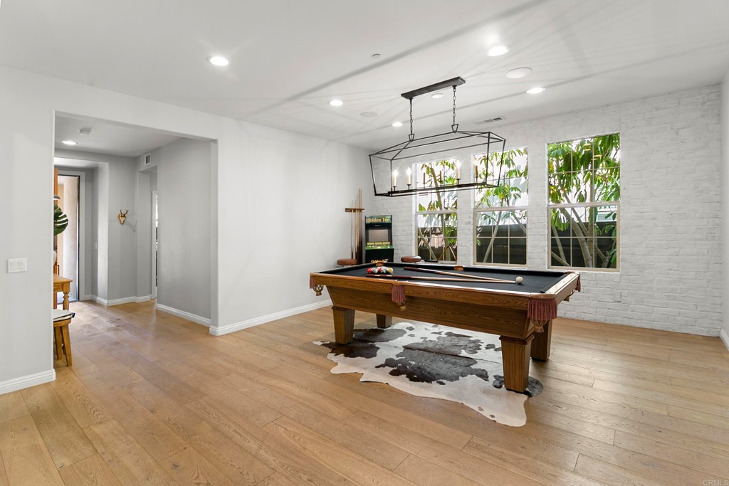 7001 Sitio Frontera Carlsbad, CA 92009 - Photo 18 of 40 a room with pool table wooden floor and windows