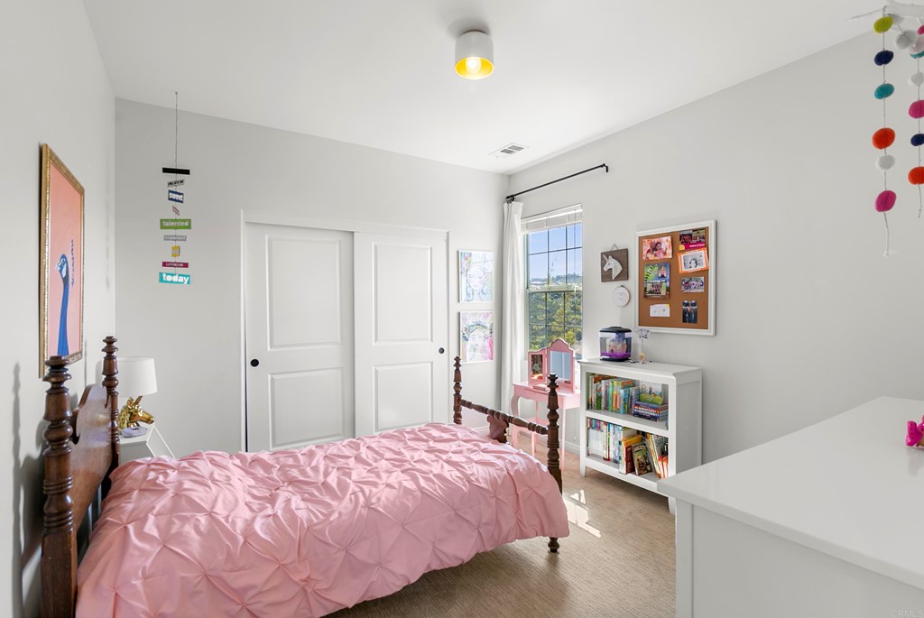 7001 Sitio Frontera Carlsbad, CA 92009 - Photo 19 of 40 a bedroom with a bed and a cabinets