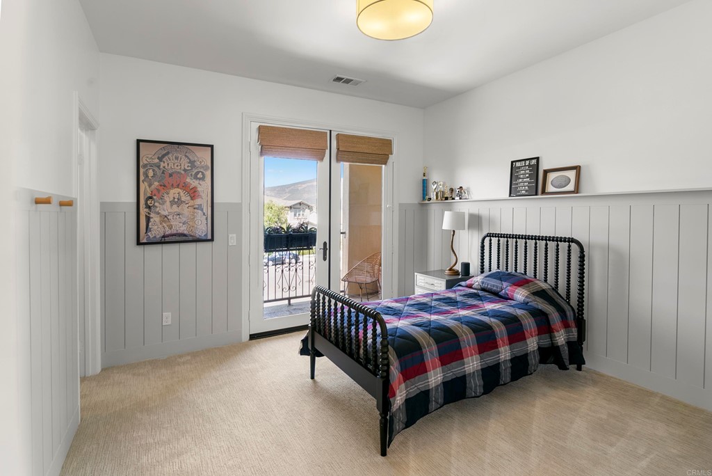 7001 Sitio Frontera Carlsbad, CA 92009 - Photo 21 of 40 a bedroom with a bed and painting on the wall