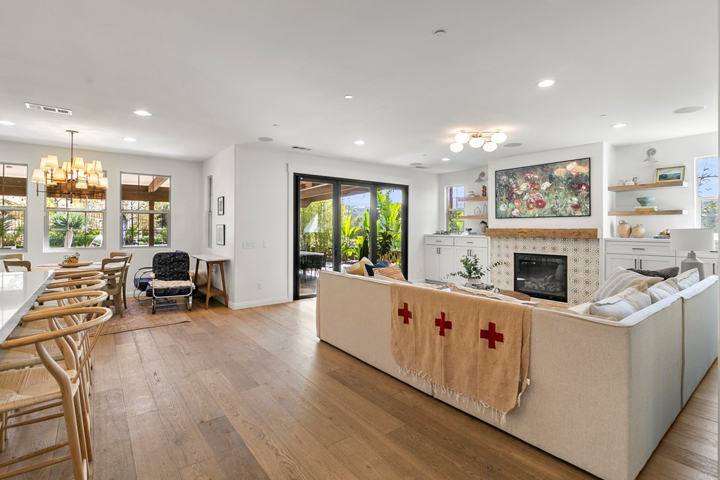 7001 Sitio Frontera Carlsbad, CA 92009 - Photo 33 of 40 a living room with furniture a fireplace and a large window
