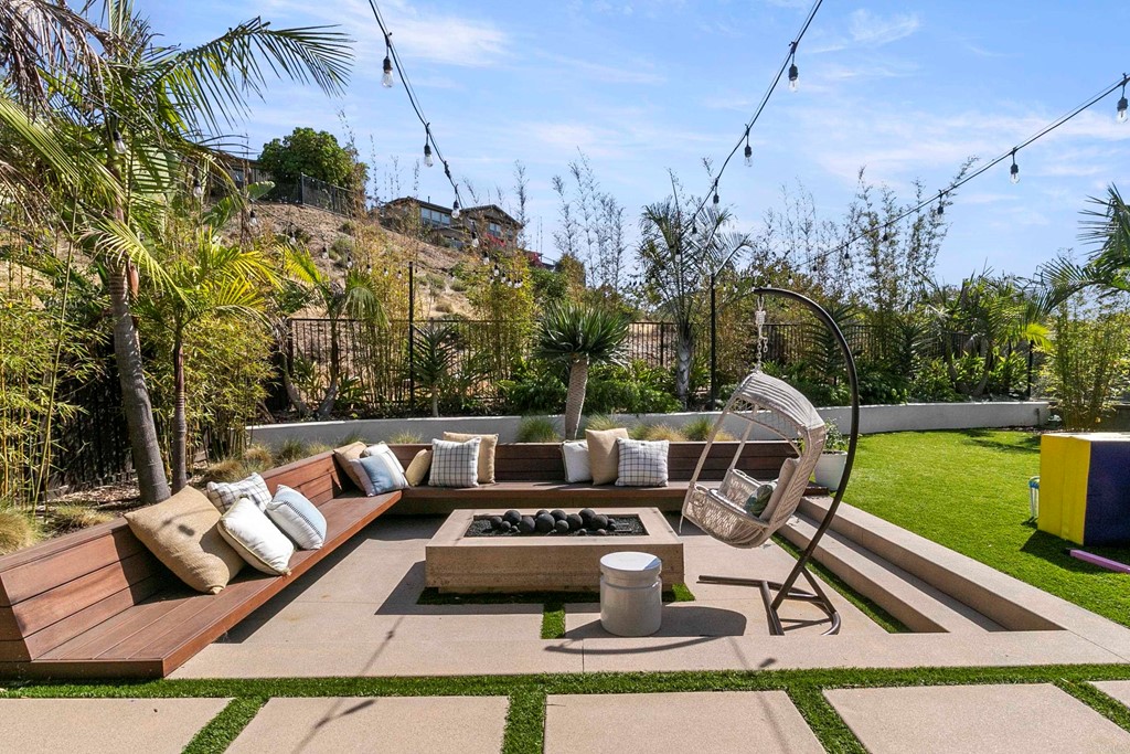 7001 Sitio Frontera Carlsbad, CA 92009 - Photo 36 of 40 a view of a patio with couches table and chairs with a yard
