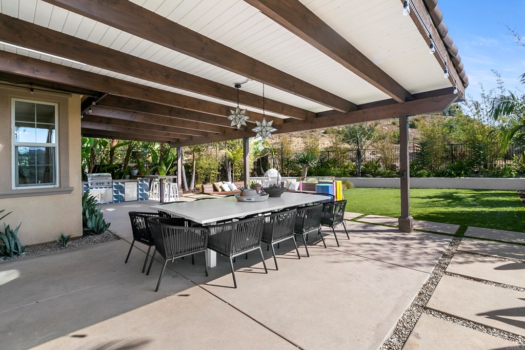 7001 Sitio Frontera Carlsbad, CA 92009 - Photo 38 of 40 a view of a patio with table and chairs under an umbrella
