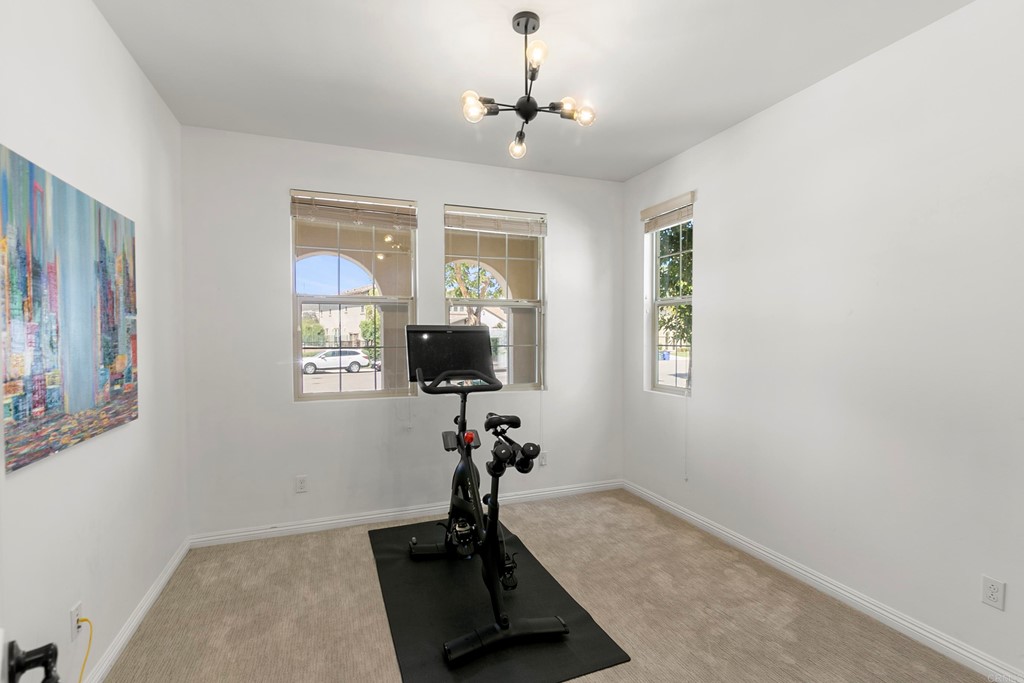 7001 Sitio Frontera Carlsbad, CA 92009 - Photo 4 of 40 a room with gym equipment and a potted plant