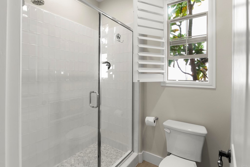 7001 Sitio Frontera Carlsbad, CA 92009 - Photo 6 of 40 a bathroom with a toilet and a shower