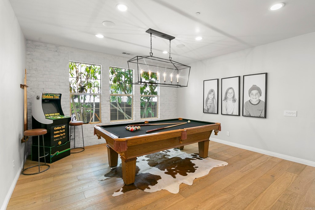 7001 Sitio Frontera Carlsbad, CA 92009 - Photo 7 of 40 a room with furniture pool table gym equipment and a large window