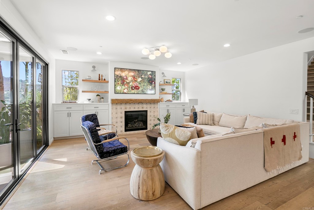 7001 Sitio Frontera Carlsbad, CA 92009 - Photo 10 of 40 a living room with furniture and a fireplace