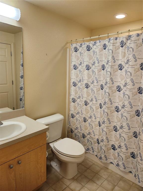 1216 Rio De Janeiro Avenue, Unit 301 Punta Gorda, FL 33983 - Photo 11 of 15 a bathroom with a toilet and a shower curtain