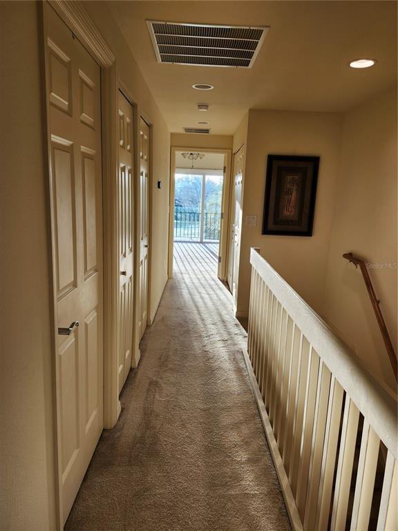 1216 Rio De Janeiro Avenue, Unit 301 Punta Gorda, FL 33983 - Photo 13 of 15 a view of a hallway with wooden floor and windows