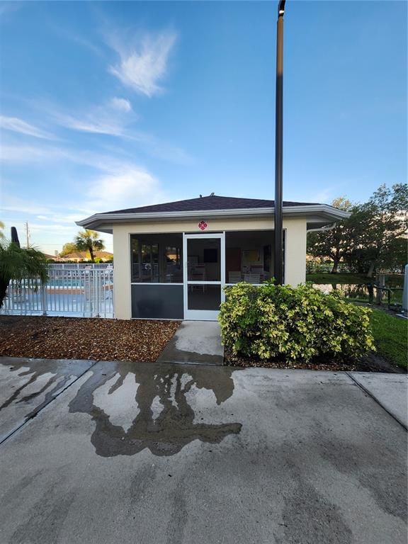 1216 Rio De Janeiro Avenue, Unit 301 Punta Gorda, FL 33983 - Photo 14 of 15 a front view of a house with a yard