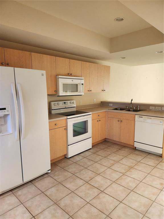 1216 Rio De Janeiro Avenue, Unit 301 Punta Gorda, FL 33983 - Photo 3 of 15 a kitchen with stainless steel appliances granite countertop a refrigerator sink and stove
