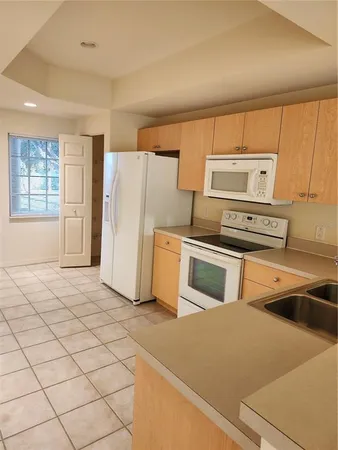 a kitchen with a stove and a refrigerator