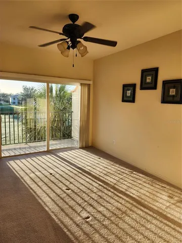 a view of a livingroom with a ceiling fan and window