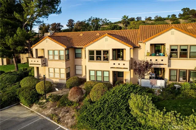 an aerial view of a house with a big yard and potted plants