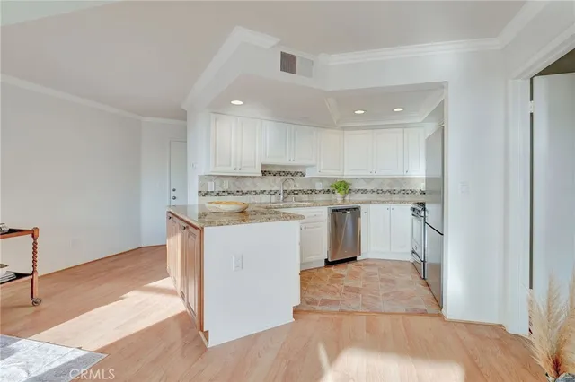 a kitchen with a stove a sink and a refrigerator