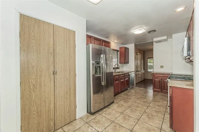 a kitchen with stainless steel appliances a refrigerator and a stove