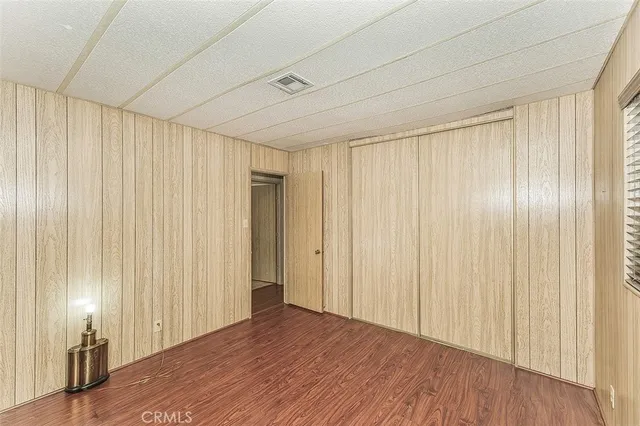 a view of a room with wooden floor