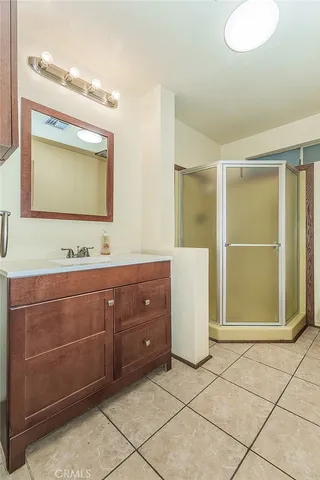 a bathroom with a sink vanity and mirror