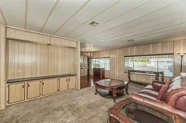 a living room with furniture a window and ceiling fan