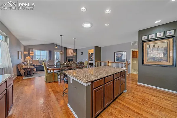 a kitchen with counter space and wooden floor