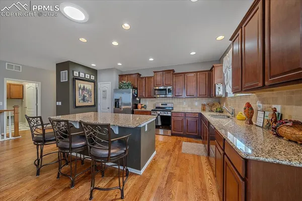 a kitchen with granite countertop lots of counter top space and stainless steel appliances