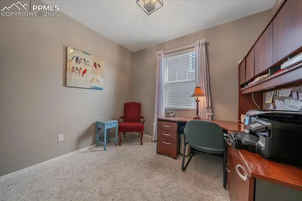 a view of a livingroom with workspace and a window