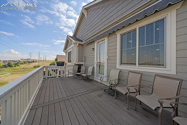 a view of a balcony with chair and wooden floor
