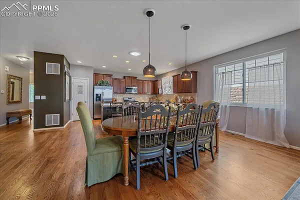 a view of a dining room with furniture window and wooden floor