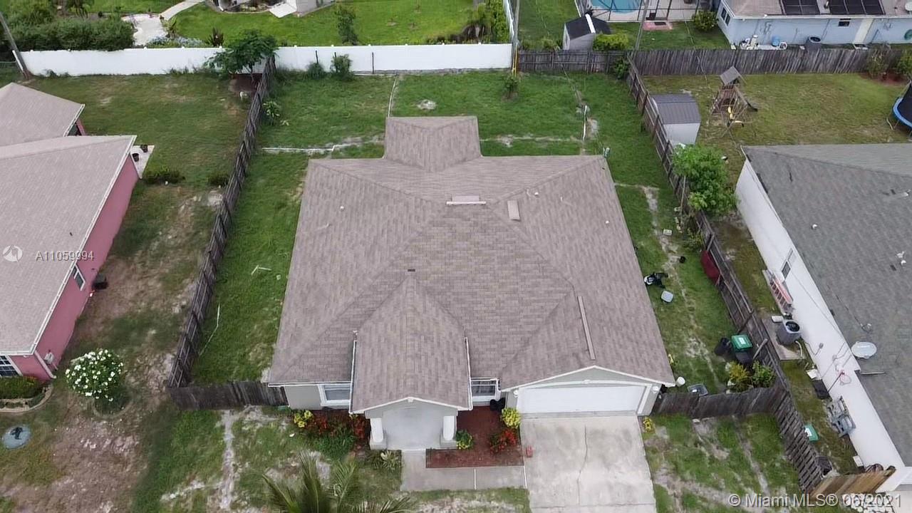 371 Southwest Undallo Road Port St. Lucie, FL 34953 - Photo 22 of 22 an aerial view of a house with a yard and lake view