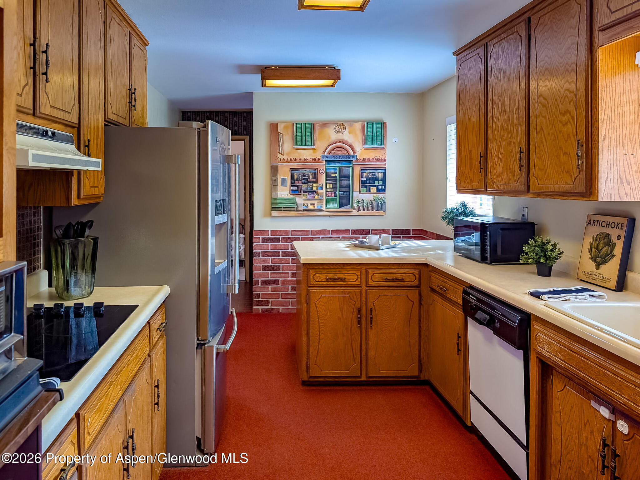 410 Fairway Avenue Rifle, CO 81650 - Photo 11 of 37 a kitchen with stainless steel appliances granite countertop a sink stove and refrigerator