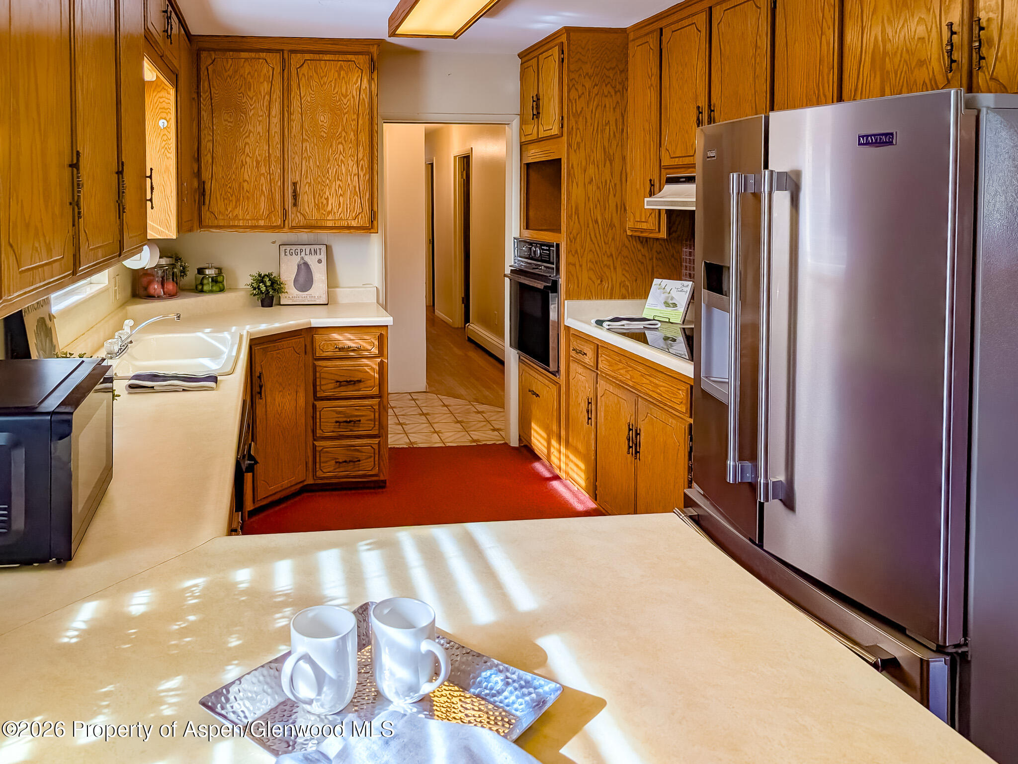 410 Fairway Avenue Rifle, CO 81650 - Photo 13 of 37 a kitchen with stainless steel appliances a refrigerator and a stove
