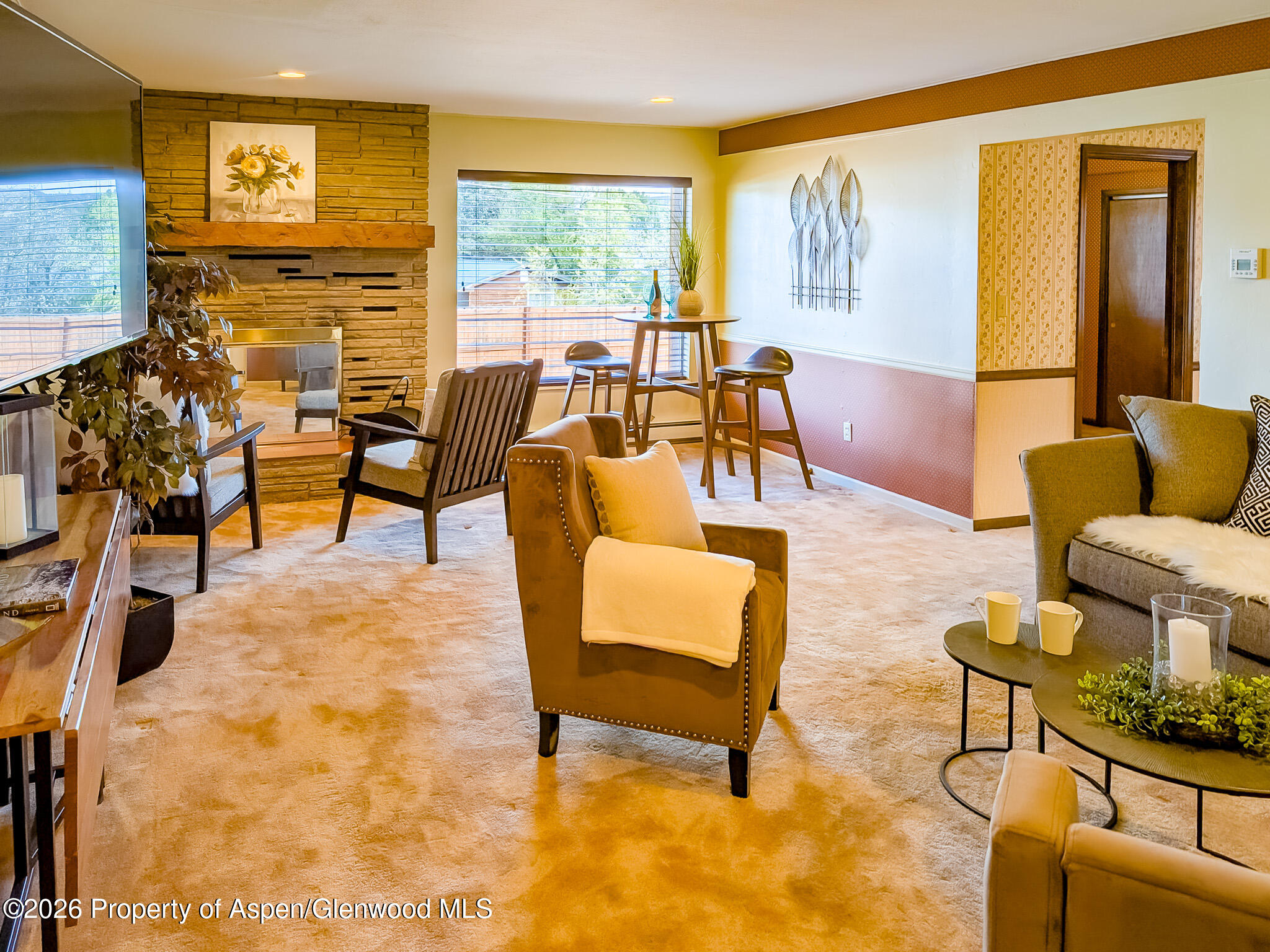 410 Fairway Avenue Rifle, CO 81650 - Photo 3 of 37 a living room with furniture and a floor to ceiling window
