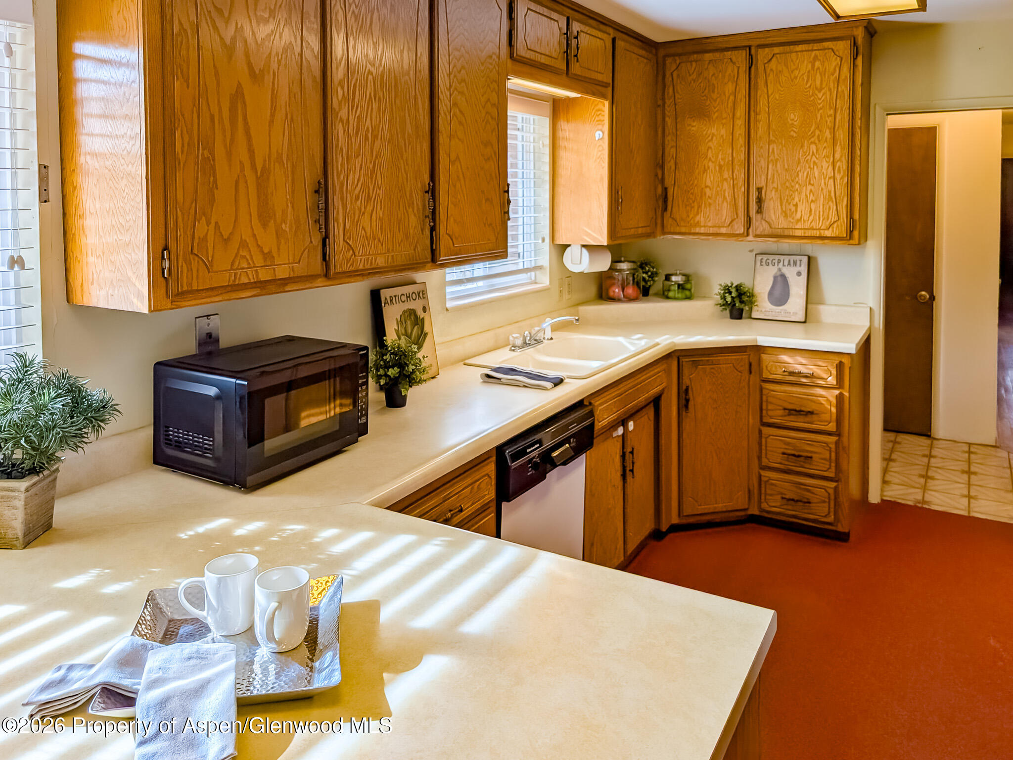 410 Fairway Avenue Rifle, CO 81650 - Photo 10 of 37 a kitchen with stainless steel appliances granite countertop a sink a stove and a refrigerator