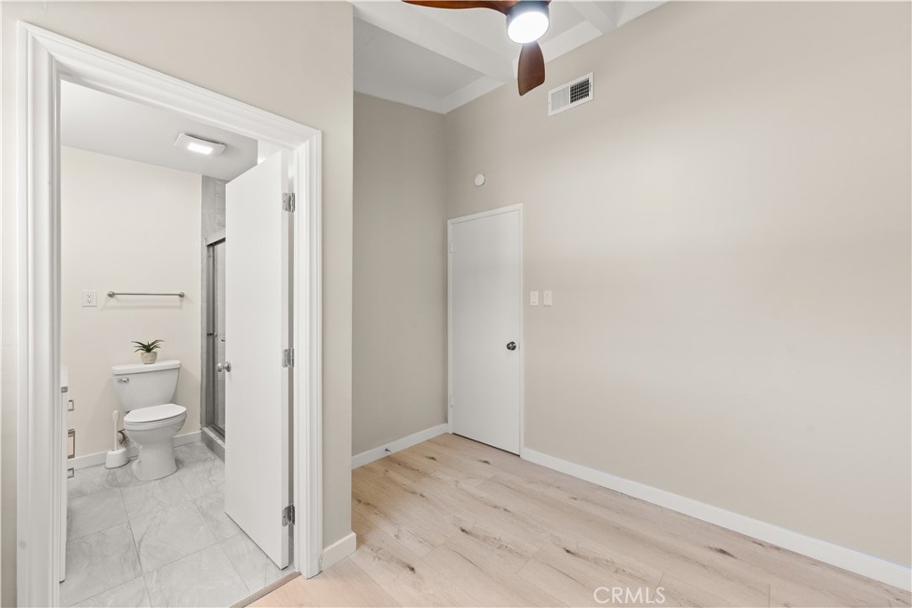 17042 Rorimer Street La Puente, CA 91744 - Photo 14 of 31 Bedroom with a private ensuite bath, featuring a step-in shower and custom glass doors.