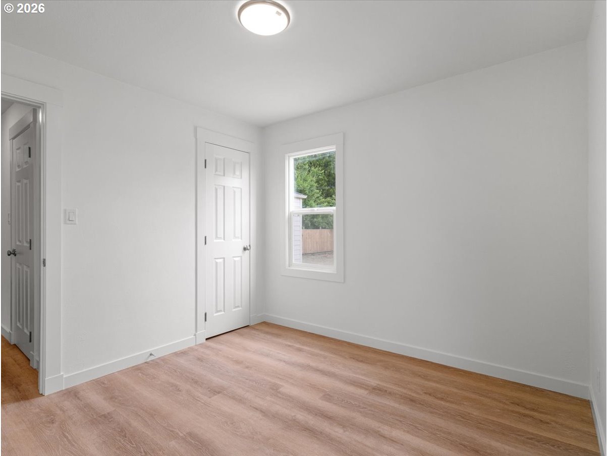 440 25th Avenue Longview, WA 98632 - Photo 11 of 27 an empty room with wooden floor and windows