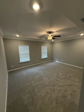 a view of a livingroom with an empty space and a ceiling fan