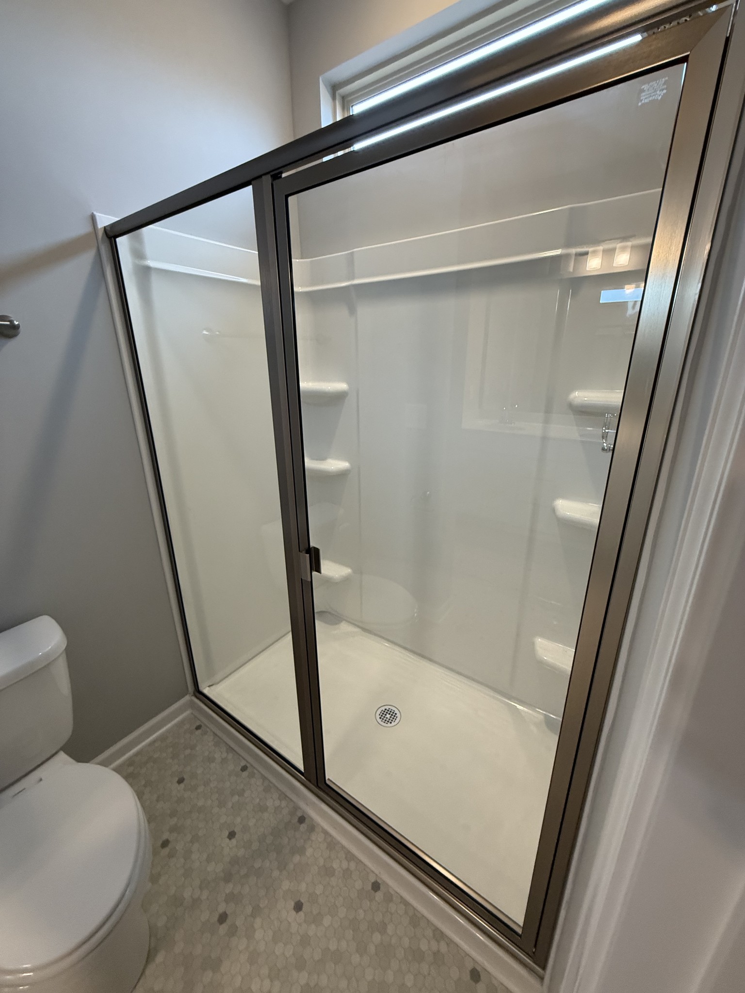 525 Windflower Pass Antioch, TN 37013 - Photo 14 of 22 a bathroom with a glass shower door