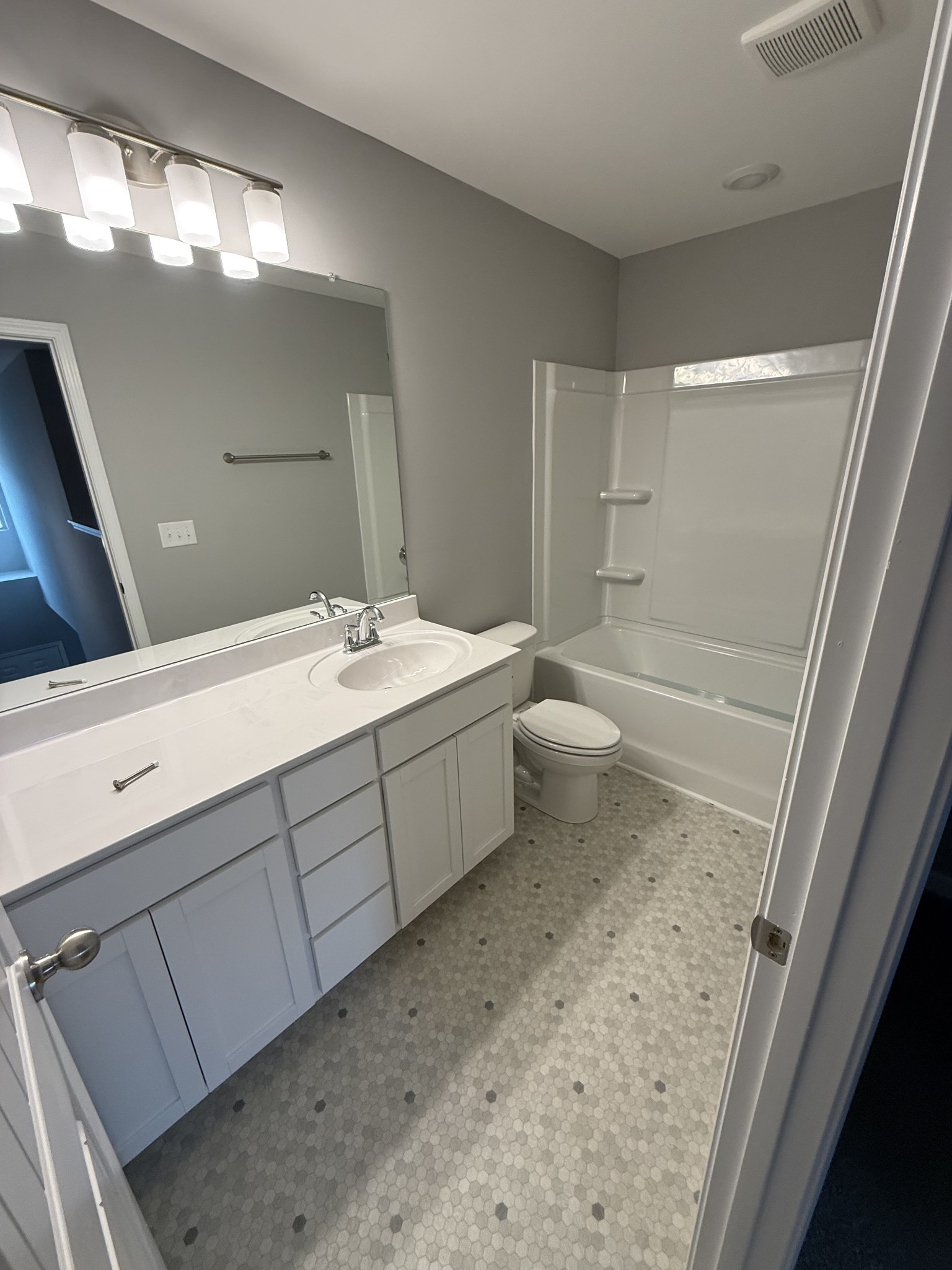 525 Windflower Pass Antioch, TN 37013 - Photo 18 of 22 a bathroom with a double vanity sink toilet and shower