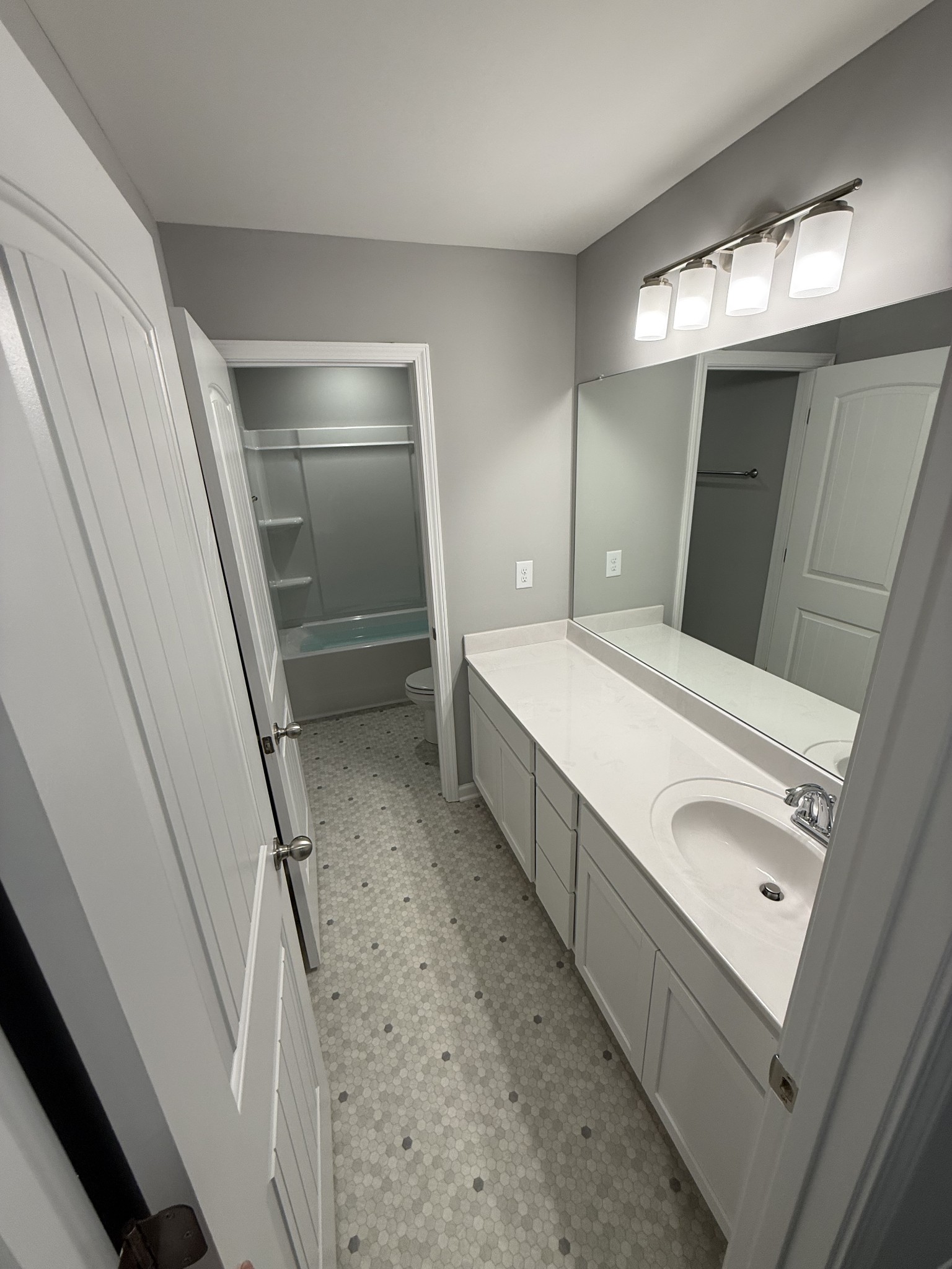525 Windflower Pass Antioch, TN 37013 - Photo 20 of 22 a bathroom with a double vanity sink a toilet and a mirror