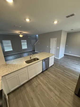 a large kitchen with stainless steel appliances granite countertop a sink and a stove