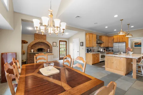 a living room with furniture a chandelier and a large window