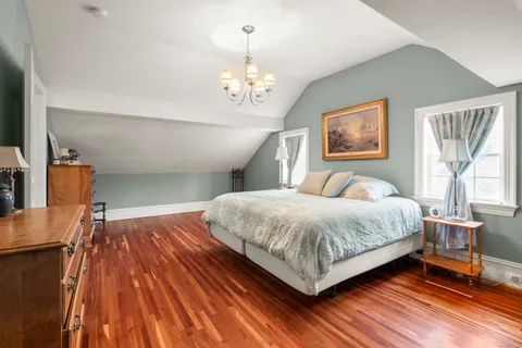 a bedroom with a bed and a dresser in it