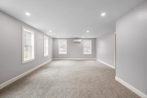 an aerial view of a house with a yard and garden in front of it