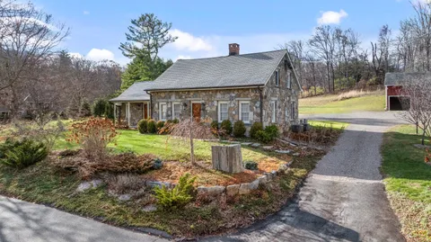 a view of a house with swimming pool and garden
