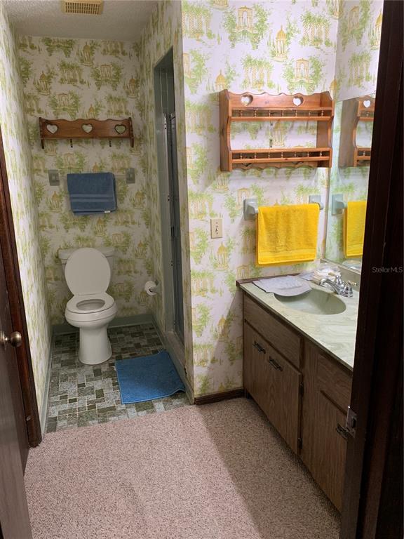 4661 Anderson Road, Unit 4661 Kissimmee, FL 34746 - Photo 5 of 14 a bathroom with a sink a toilet and shower